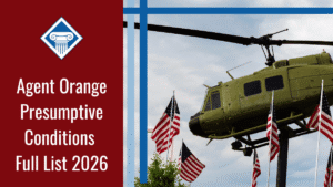 An image of a helicopter and U.S. flags against a blue sky at a Vietnam War memorial. Alongside the image is a red banner reading the article title: Agent Orange presumptive conditions full list 2026
