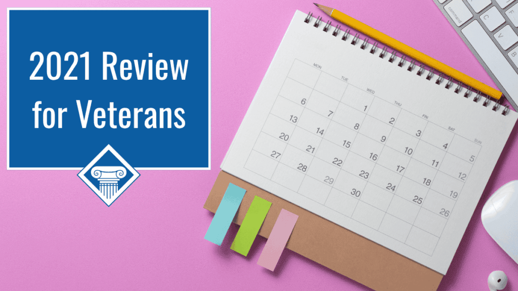 Photo of a calendar lying on a pink background with colorful sticky notes stuck to the bottom left side. Article title is in the upper lefthand corner: 2021 Review for Veterans.